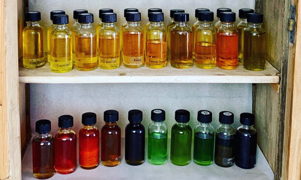 a selection of antioxidant rich oils in a range of colors displayed in a cupboard 